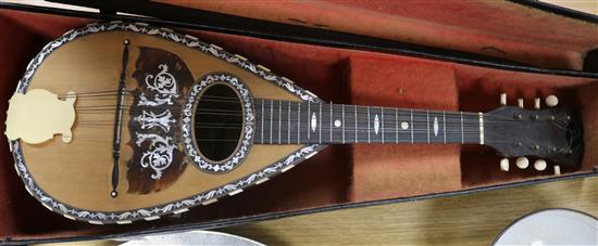 A cased Pietro Tonelli mandolin